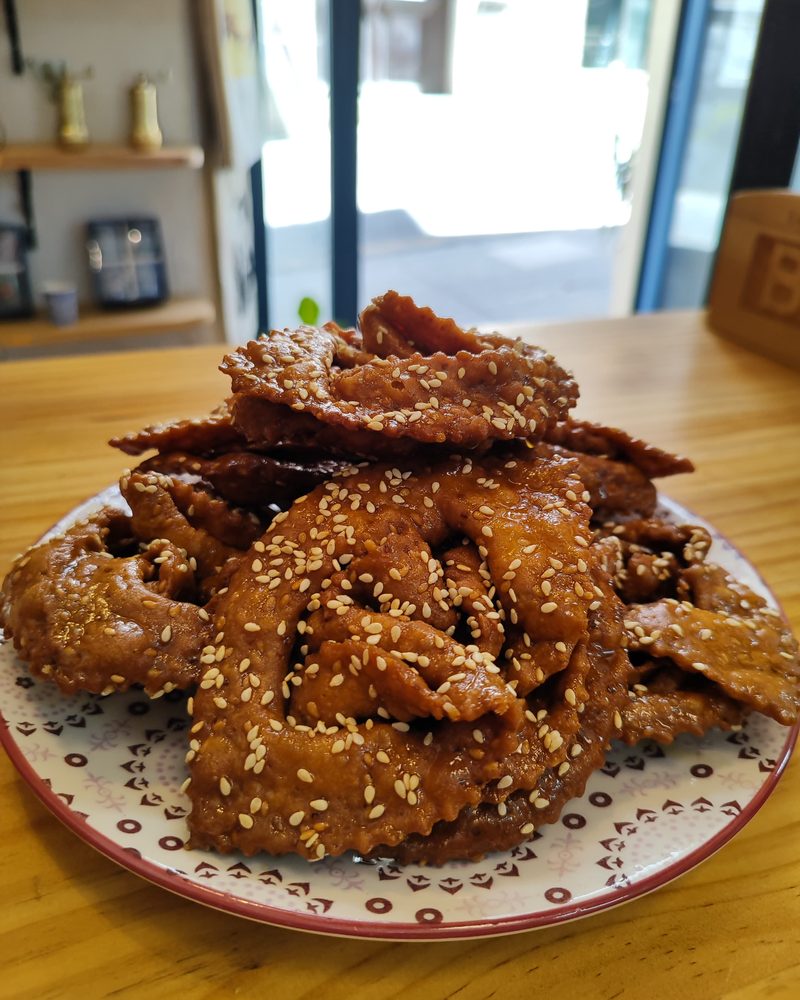 Fried sesame pastries piled on a plate